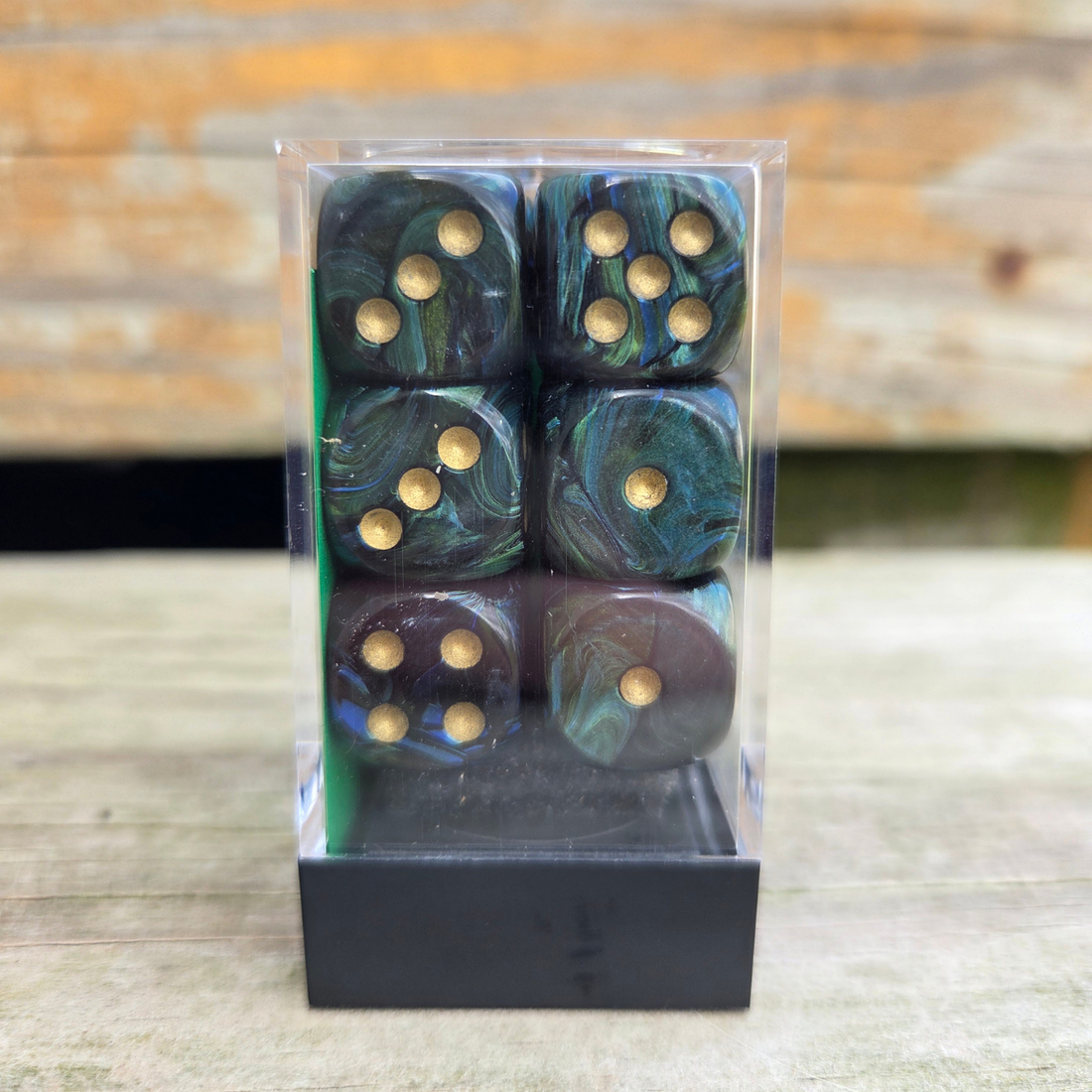 set of 12 six-sided dice in a clear plastic container