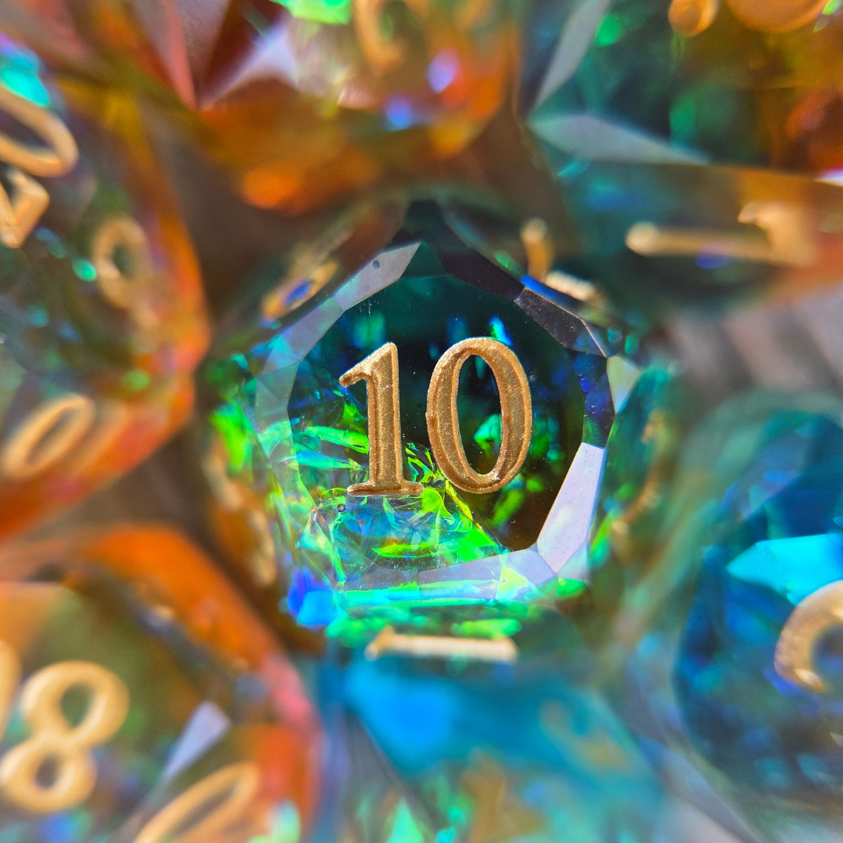 close-up of a d10 with holographic foil and gold numbers