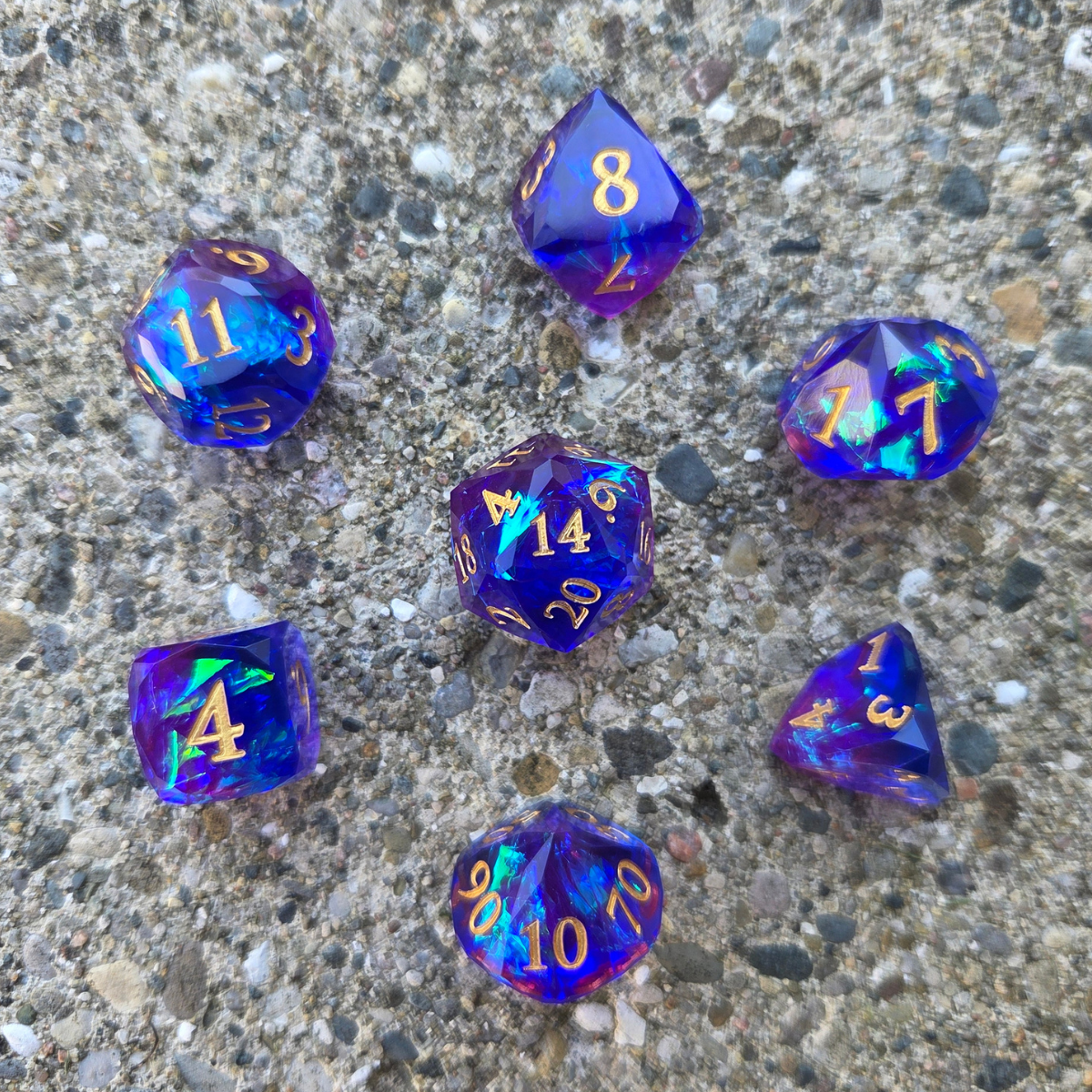 Set of colorful polyhedral dice on a concrete surface