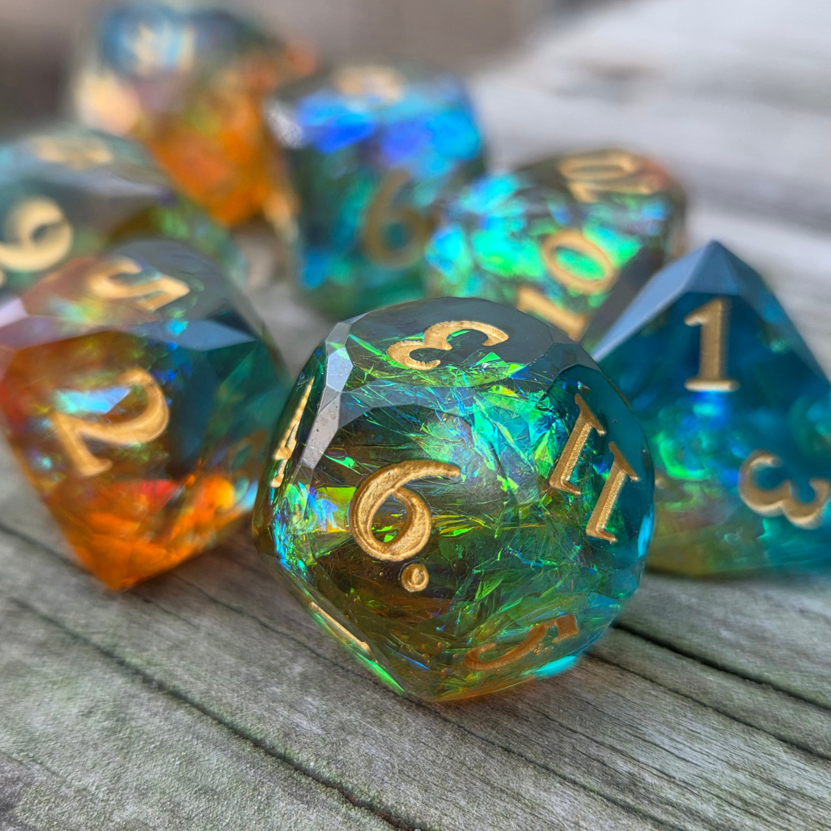 Set of colorful dice with holographic foils and sitting on a wooden surface