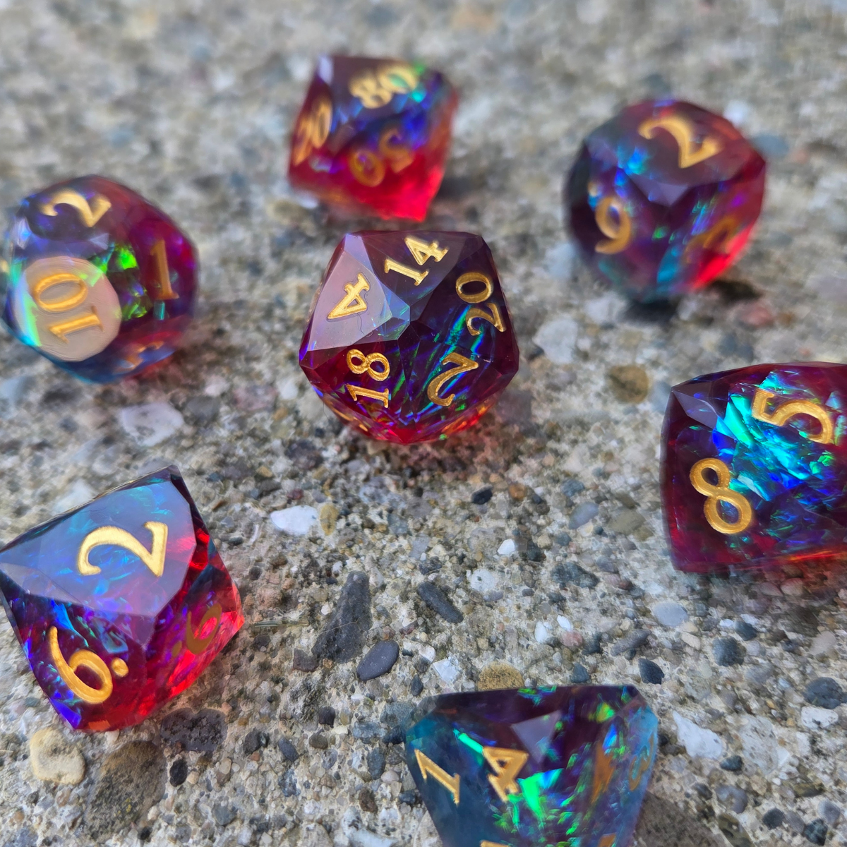 Set of colorful polyhedral dice on a concrete surface