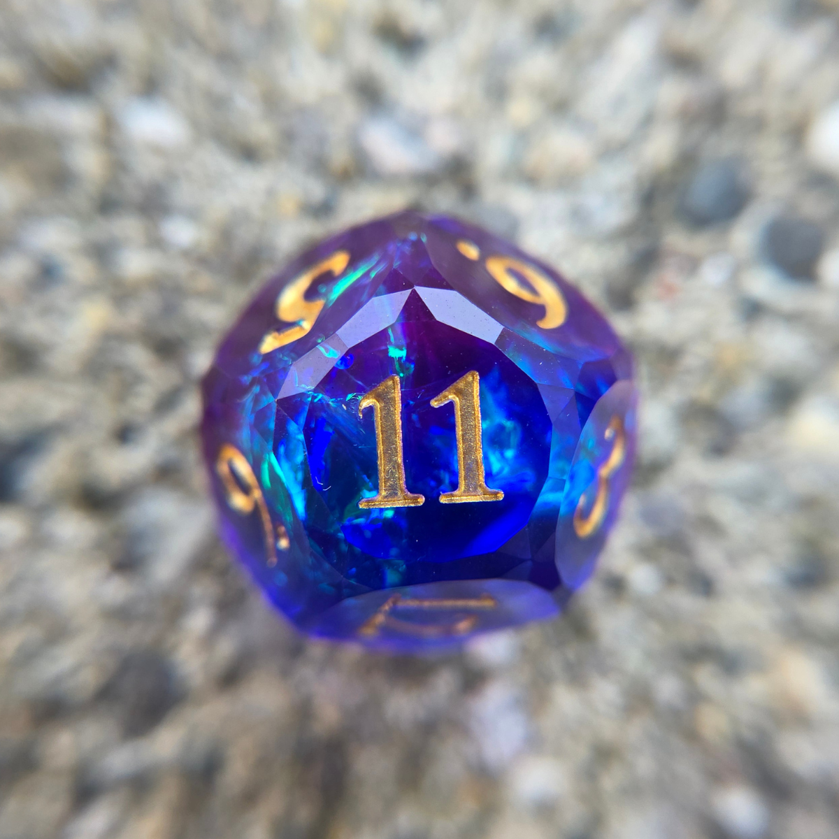 Close up of a d12 featuring a gold number 11