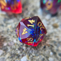 A reddish d20 sanded and polished to look like a gemstone