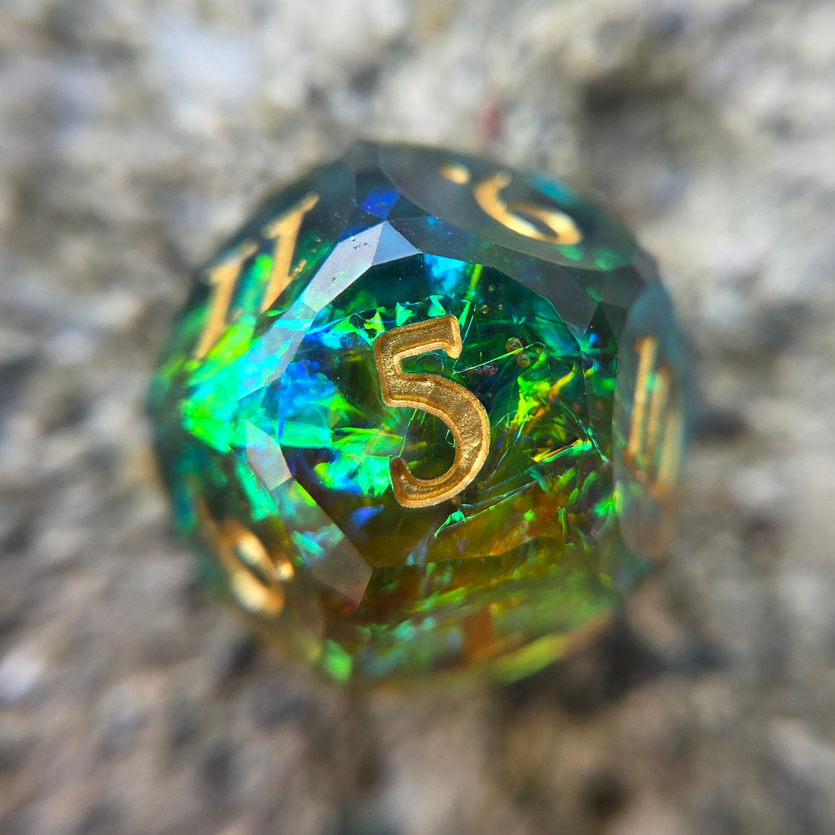 Multicolored green and oranged12 with gold numbers and holographic foil, sitting on a textured background