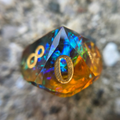 Multicolored d10 featuring a gold number 0
