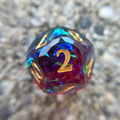 A red and blue die with gold numbers and multicolored holographic foil