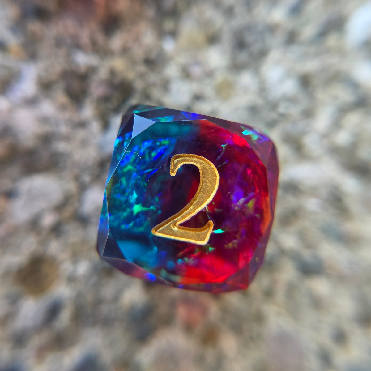 A six-sided die that is perfectly blue on one side and perfectly reddish purple on the other