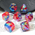 Set of colorful polyhedral dice on textbook page and a plate