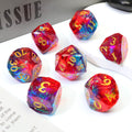 Set of colorful polyhedral dice with numbers, sitting on a tabletop with a gray book in the background