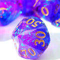 Multicolored polyhedral dice with gold numbers on a white background