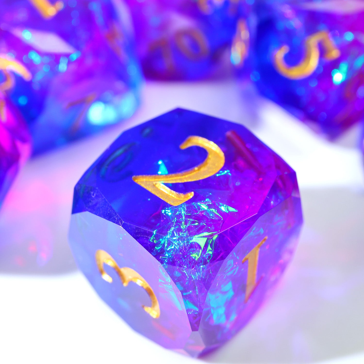 Semi-translucent purple polyhedral dice with gold numbers and holographic foils