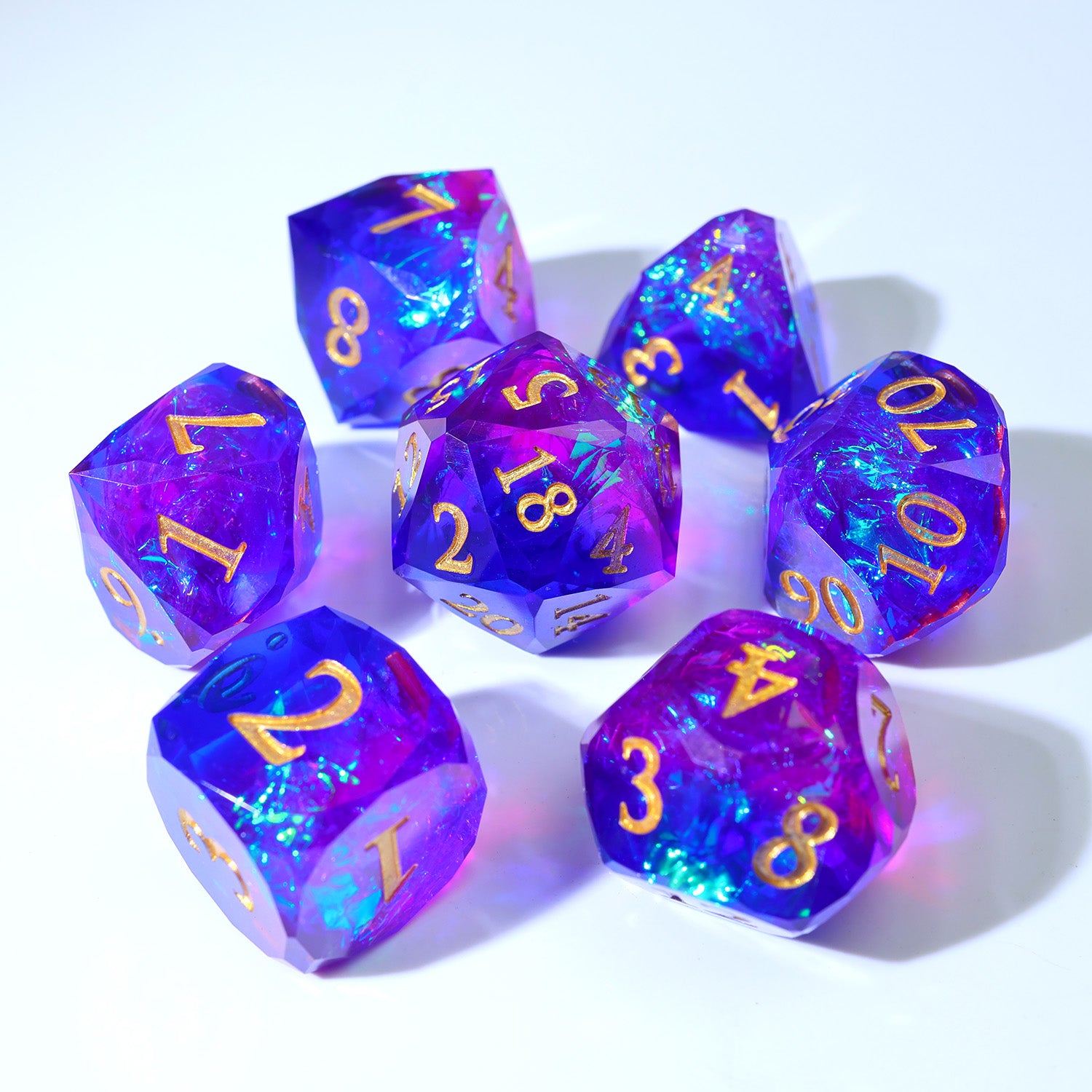 Set of purple polyhedral dice with gold numbers on a white background