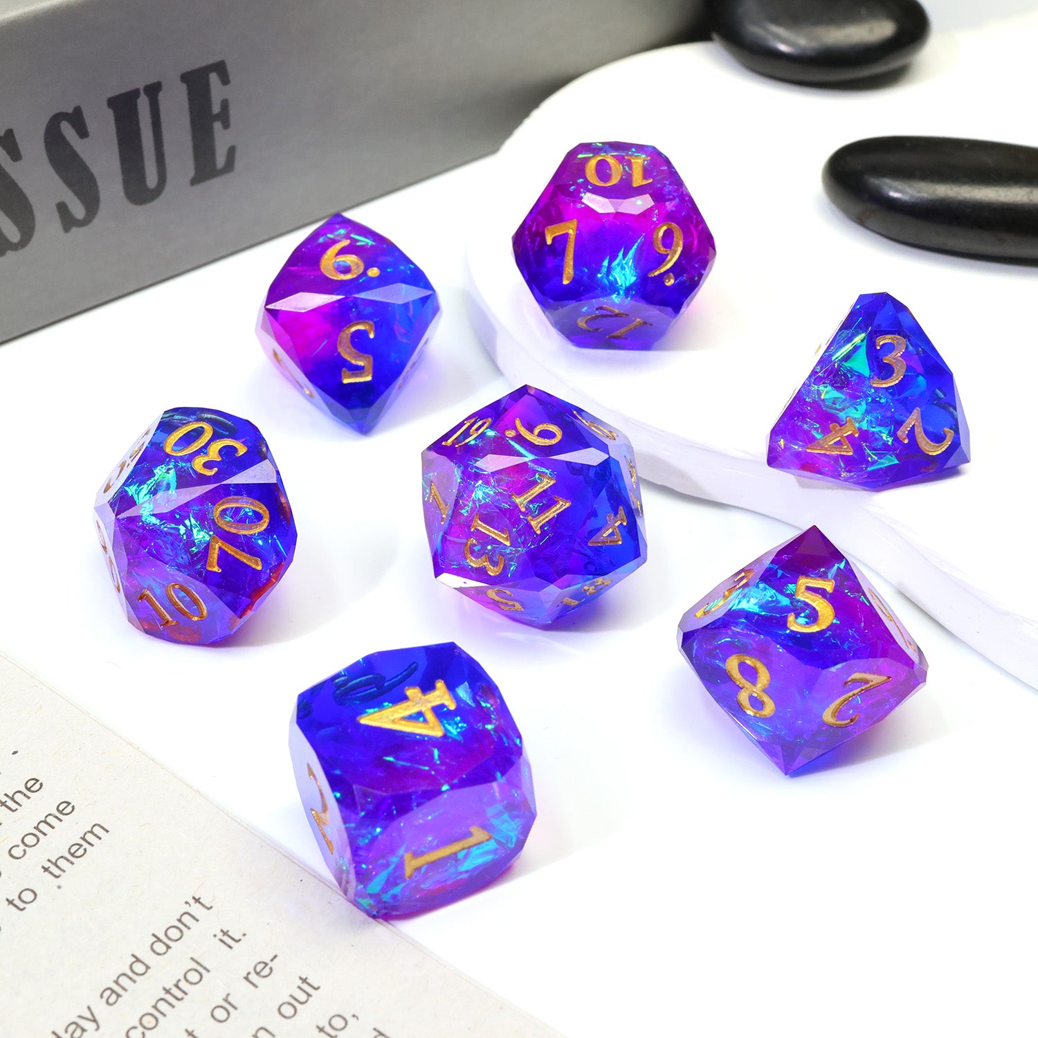 Set of purple polyhedral dice sitting on a tabletop