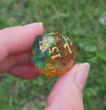 Video of a multicolored d20 viewed at all angles to show off how the color changes depending on which angle it's viewed