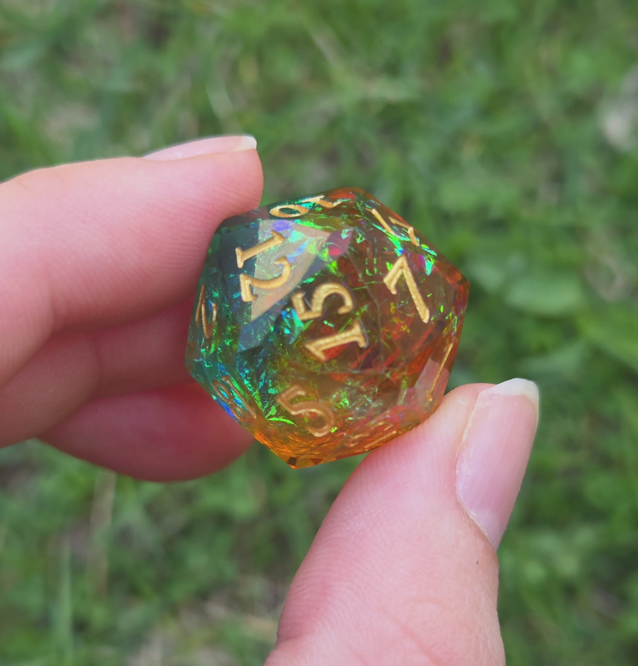 Video of a multicolored d20 viewed at all angles to show off how the color changes depending on which angle it's viewed