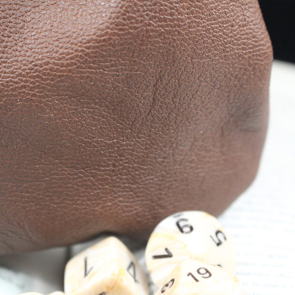 Close up of grain on brown leather dice bag